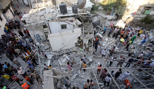 Rescue workers search for victims as Palestinians gather around the wreckage of a house in Rafah